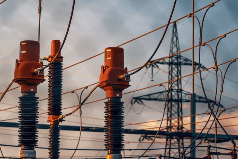 High-voltage substation equipment at dusk, symbolizing OT network visibility gaps in grid infrastructure