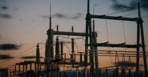 Satellite cellular backup for utilities: an electrical substation silhouetted against a dusk sky